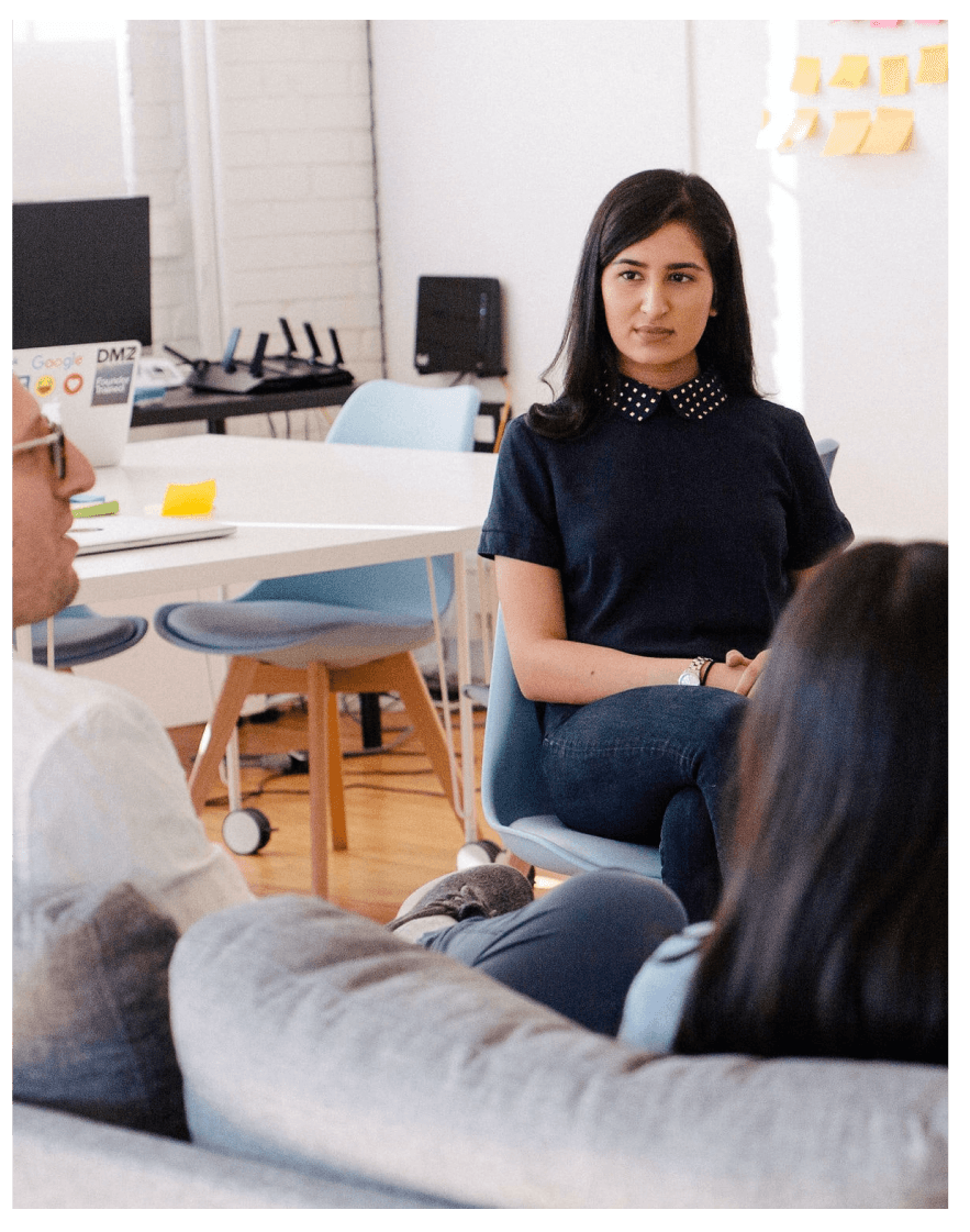 Three people chatting in casual meeting